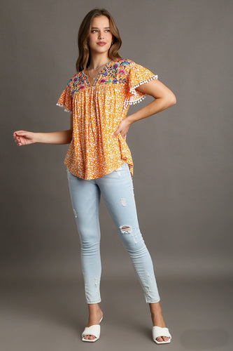 Umgee Animal Print Top with Flower Embroidery and Pom Pom Fringe Detail in Tangerine Top Umgee   