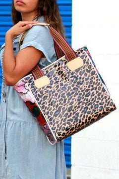 Woman carrying leopard print tote bag