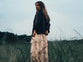 woman wearing a long ruffled skirt with an oversized sweater