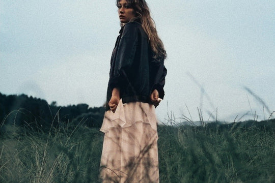 woman wearing a long ruffled skirt with an oversized sweater
