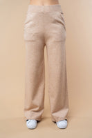 Beige wide-leg pants worn by a person on a beige background