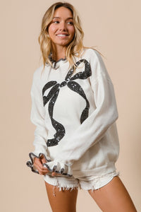 BiBi Knit Sweater with Large Sequin Bow and Ruffle Details in Off White