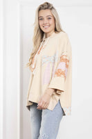 BlueVelvet Terry Knit Pullover Top with Contrasting Print Bow Patches and Stripes in Natural