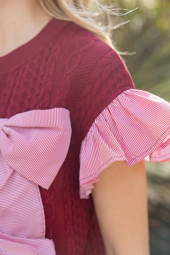 VOY Cable Knit Top with Striped Cuffs and Large Bow Front in Red