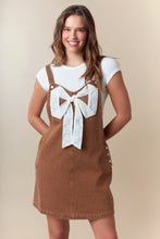 Load image into Gallery viewer, Fantastic Fawn Overall Mini Dress with Ribbon Bow Front in Camel
