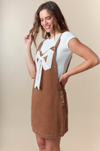 Load image into Gallery viewer, Fantastic Fawn Overall Mini Dress with Ribbon Bow Front in Camel
