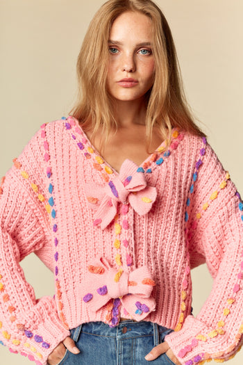 RARERAW Pom-Pom Knit Cardigan With Rainbow Bow Accents in Candy Pink