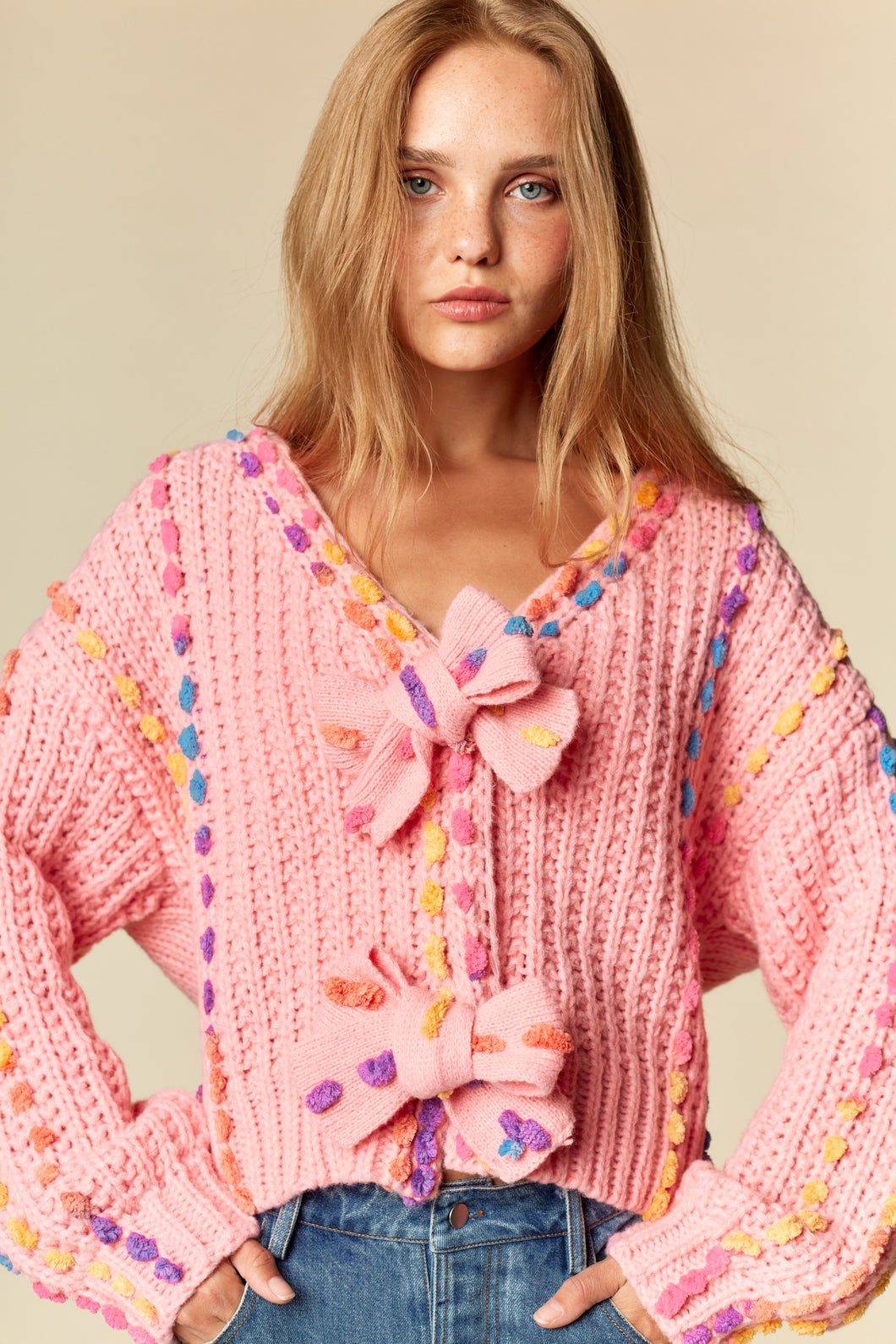 RARERAW Pom-Pom Knit Cardigan With Rainbow Bow Accents in Candy