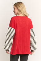 HEIMISH Textured Knit Top with Sequin Santa Bow and Contrasting Striped Sleeves in Red