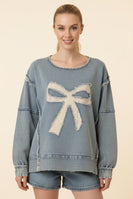Heimish Eyelet Bow Applique Raw Edge Sweatshirt in Light Denim