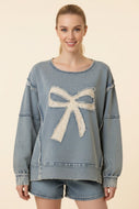 Heimish Eyelet Bow Applique Raw Edge Sweatshirt in Light Denim