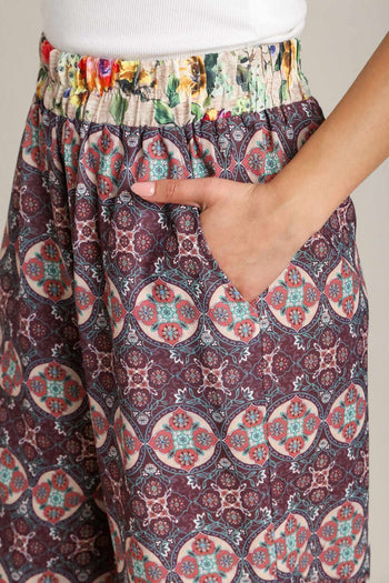 Umgee Wide Fit Mixed Print Bottoms with Elastic Waistband & Side Pockets in Maroon Mix