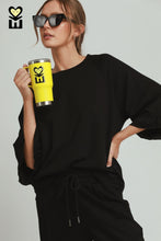 Load image into Gallery viewer, Umgee Luxeknit Round Neck Ruffle Tier Raglan Sleeve Top in Black
