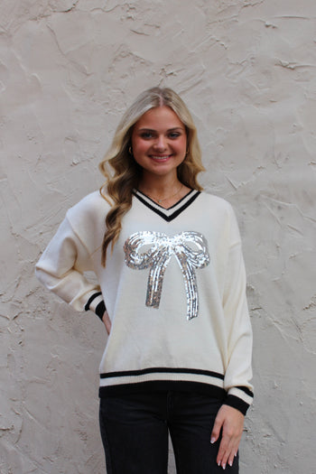 Emma+Grace Varsity Sweater with Sequin Bow on Front in Cream