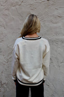 Emma+Grace Varsity Sweater with Sequin Bow on Front in Cream