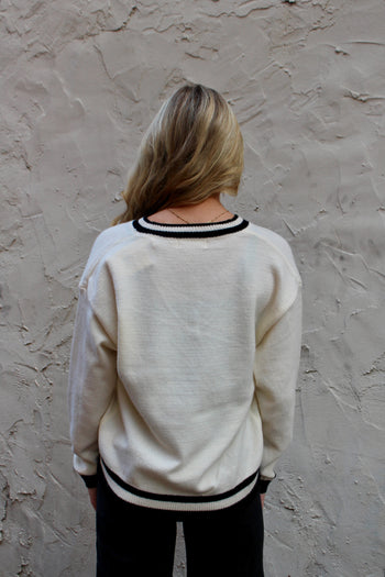Emma+Grace Varsity Sweater with Sequin Bow on Front in Cream