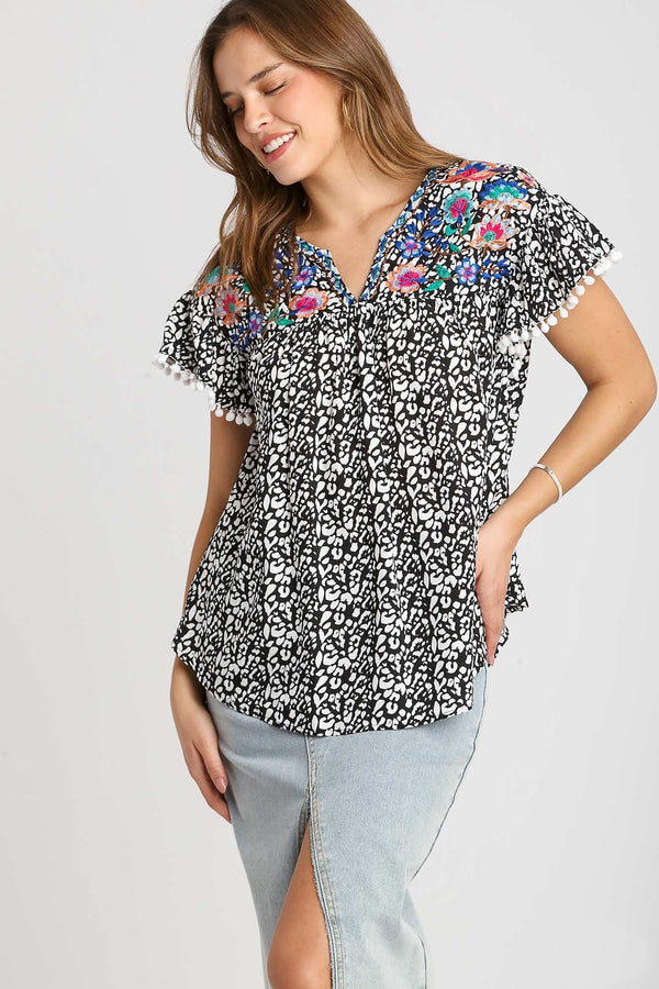 Umgee Animal Print Top with Flower Embroidery and Pom Pom Fringe Detail in Black Top Umgee   