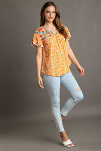 Umgee Animal Print Top with Flower Embroidery and Pom Pom Fringe Detail in Tangerine Top Umgee   