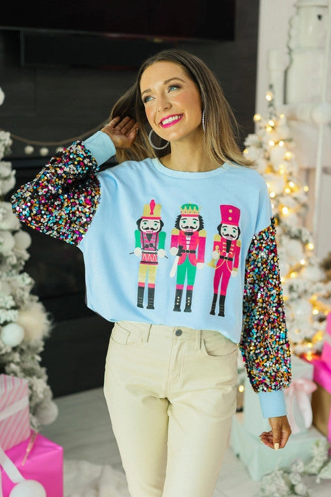 Grace+Emma Solid Color Nutcracker Print Top with Sequin Sleeves in Blue