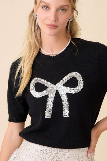 Main Strip Sweater Knit Top with Sequin Bow Front in Black