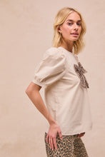 Load image into Gallery viewer, BiBi Solid Color Woven Top with Mesh Leopard Bow Front in Cream
