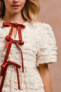 BiBi Textured Woven Peplum Bow Tie Top in Cream