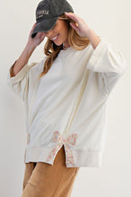 Load image into Gallery viewer, Easel Solid Color Terry Knit Top with Applique Bows on Hem in Ivory
