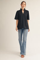 Jodifl Standing Neckline Notched V Neck Solid Color Top in Black